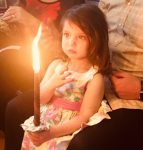 photo - Mia holds a Havdalah candle
