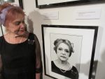 photo - Jannushka Jakoubovitch, a Holocaust survivor, looks at her portrait, taken by Pulitzer Prize-winning photographer Marissa Roth, part of the Faces of Survival exhibit at the VHEC