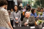 photo - Holocaust survivor Serge Haber speaks with Tina Macaspac and other students at the Writing Lives closing ceremony April 26