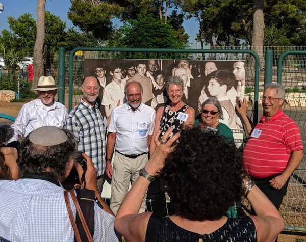 photo - From left to right, Rabbi Shawn Zell, Maury Miloff, Sam Petuchowski, Tessa Hoffman, Esti Friedman and Allan Pollack stand in front of their class photo, taken with David Ben-Gurion