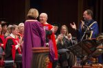 photo - Honourary degree recipient Robert Waisman, centre, is congratulated by University of Victoria chancellor Shelagh Rogers as UVic president Jamie Cassels, right, applauds.