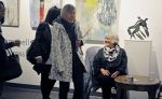 photo - Olga Campbell (seated) takes a break from signing books at the opening of her exhibit A Whisper Across Time, which also served as a launch of her book by the same name