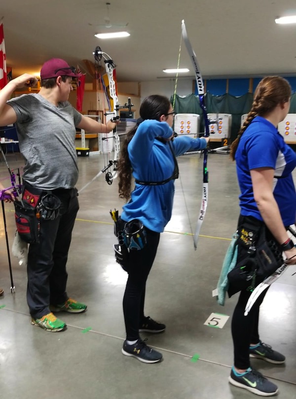 photo - Adi Shapira (centre) willcompete in archery in the 2019 Canada Winter Games