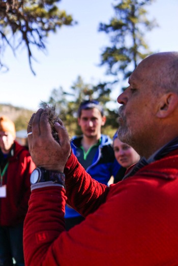 photo - Staff member Cliff Stockton teaches primitive fire building skills to students at BaMidbar