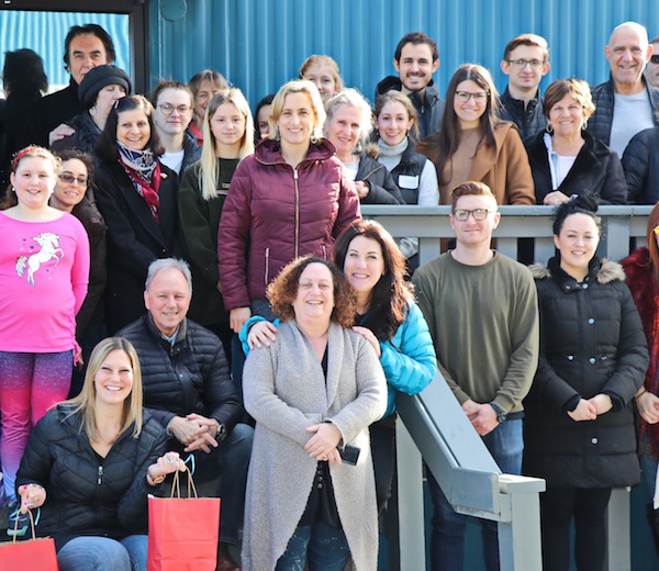 photo - Some of the 70 volunteers who helped out at Rose’s Angels Feb. 17. Event founder Courtney Cohen is holding the bags and Kehila Society executive director Lynne Fader is standing in the front, with the long sweater