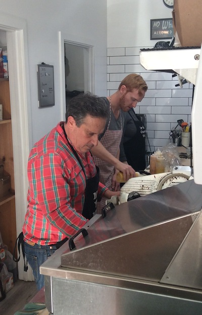 photo - Howard Busgang, left, and Adam Bogoch prepare sandwiches