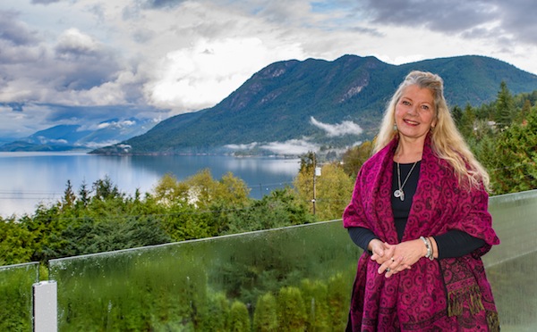 photo - Owner Cynthia Miller in front of Sechelt Inlet at the Pacific Peace Retreat