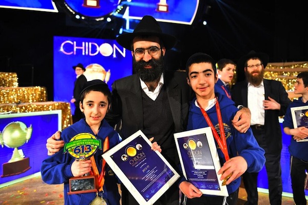 photo - Silver trophy winner Levi Bitton, 11, and medal winner Mendel Bitton, 14, with their father, Rabbi Binyomin Bitton, director of Chabad of Downtown Vancouver, at the International Chidon Sefer Hamitzvos