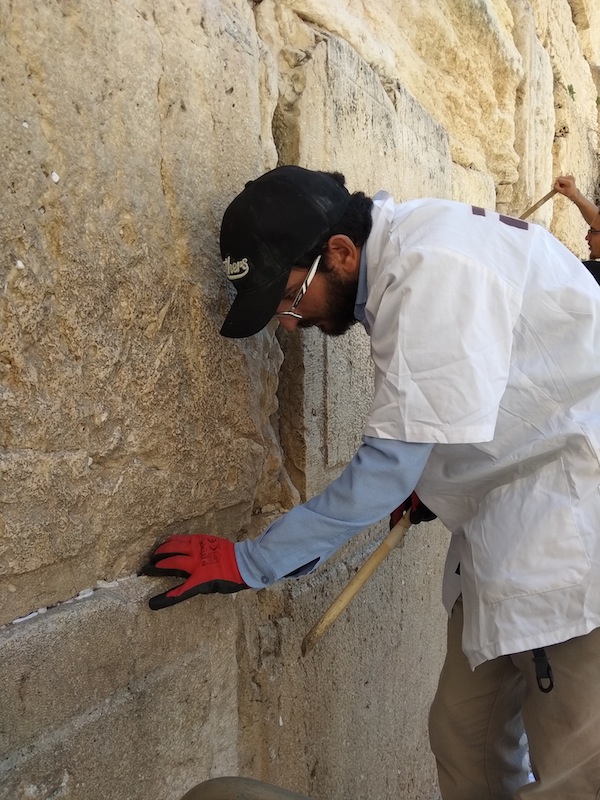 photo - Crews from the office of the Rabbi of the Western Wall remove tens of thousands of written prayers from the Western Wall