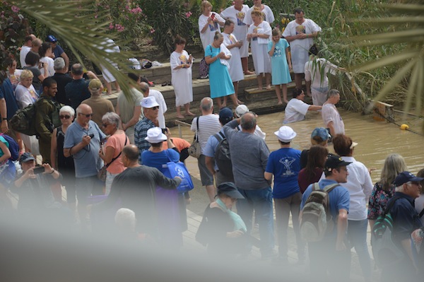 photo - Christians preparing to be baptized in the Jordan River