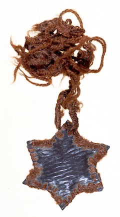 photo - Margit (Manci) Rubenstein made this Star of David necklace from material taken from the lining of her shoes and shoelaces while imprisoned in Auschwitz (1944)