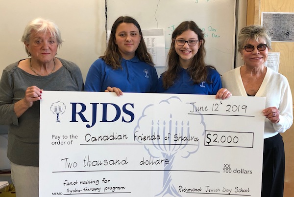 photo - Left to right are Lola Pawer, RJDS students Maya Bernal and Penina Berger, and Leslie Diamond