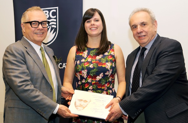 photo - Dr. Charles Ungerleider, professor emeritus of educational studies at the University of British Columbia and a former B.C. deputy minister of education, left, and Jerry Nussbaum, president of the Janusz Korczak Association of Canada, present an award to Stephanie Black, 2019 recipient of the Janusz Korczak Scholarship