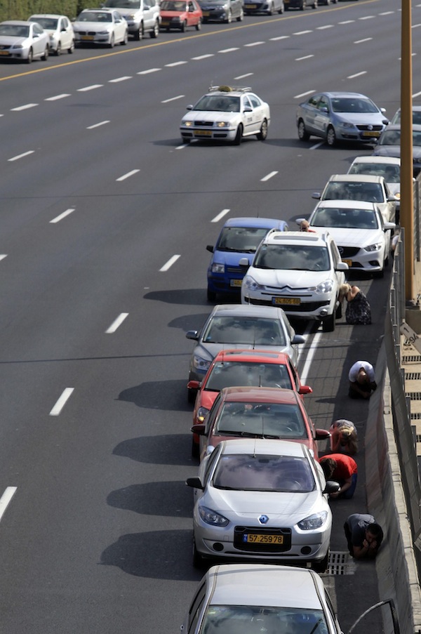 photo - Drivers take refuge from rockets in Tel Aviv, July 9, 2014