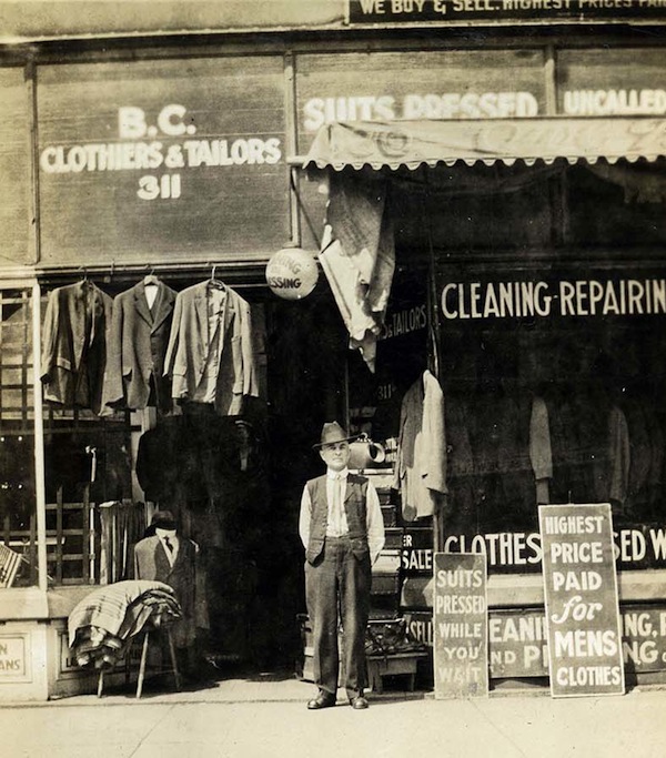 photo - An unknown man outside one of Mrs. Ann Snider's tailor shops, circa 1915
