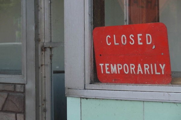 photo - "Closed, temporarily" sign in window
