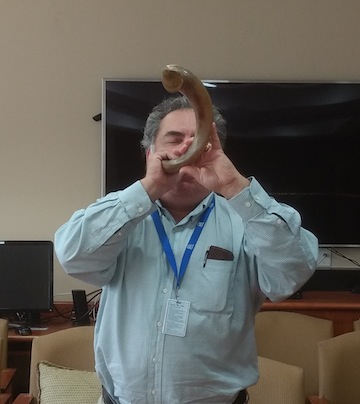 photo - Chazzan Rob Menes sounding the shofar at the Weinberg Residence