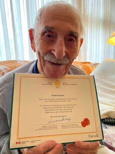 photo - Reuben Sinclair holds a birthday message from Veterans Affairs Canada