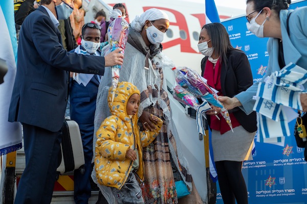 photo - Minister of Immigration and Absorption Pnina Tamano-Shata, second from the right, greets Ethiopian olim as they arrive in Israel. In November 2020, Tamano-Shata announced the planned aliyah of 2,000 olim from Ethiopia, and her ministry recently reached that target