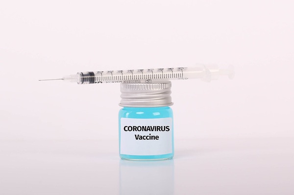 photo - Syringe and bottle with blue fluid and Coronavirus Vaccine text