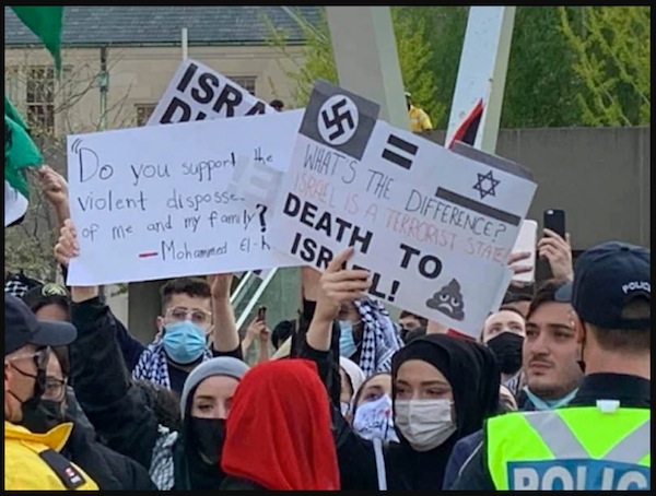 screenshot - Signs shown at a recent rally in support of Palestine