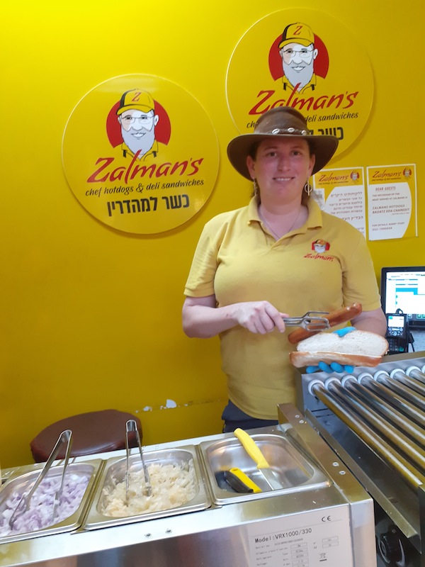 photo - Unemployed tour guide Hannah Rosenberg is now serving up hot dogs for about $12.50 Cdn an hour
