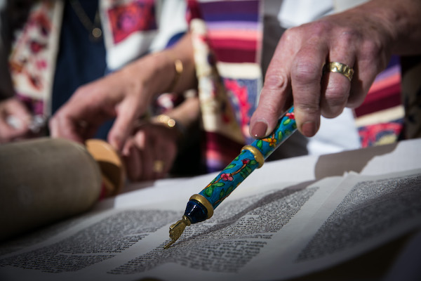 photo - woman reading Torah