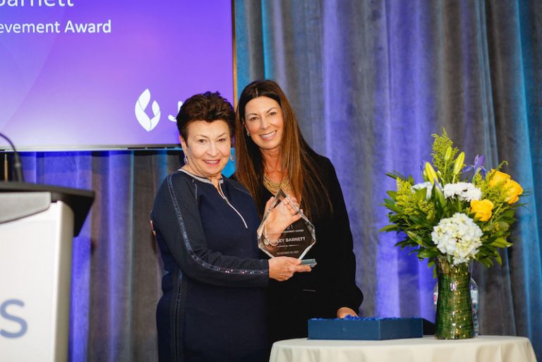 photo - Shirley Barnett holds the JFS Lifetime Achievement Award, which was presented to her by Jody Dales on behalf of the agency