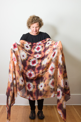 photo - Mariana Frochtengarten shows of one of her colourful Shibori shawls