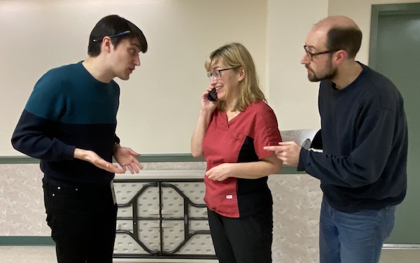 photo - Nicholas Guerriero, left, Lorene Cammiade and Rudy Smith rehearse a scene from Bema Productions’ staging of Men Overboard, which will be at Emanu-El Synagogue’s Black Box Theatre May 5-15. Guerriero plays Jay Silver, a Buddhist monk and the youngest son of Zaida Ernie, Cammiade portrays Eva Fuzesi, the bar mitzvah tutor from Hungary, and Smith plays Doug Silver, Ernie’s middle son and a psychotherapist