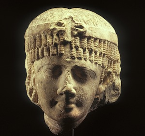 photo - Shown wearing a heavy wig, the queen also has a headband with a coiled uraeus serpent above her brow. Of the seven Ptolemaic queens named Cleopatra, this head may represent Cleopatra II or her daughter, Cleopatra III