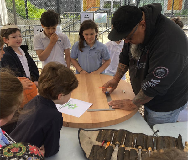 photo - Gerry Sheena shows students his method of carving