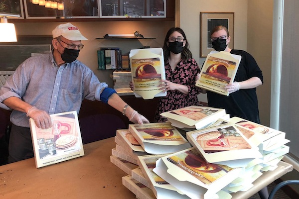 photo - Ambassadors of Light putting together more than 2,000 packages of matzah at Lubavitch BC