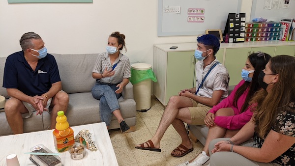 photo - JNF Pacific region executive director Michael Sachs, left, in a meeting at Aviv House for autistic adults in Israel