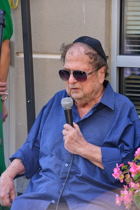 photo - Dr. Norman Stein, who has been a resident at the Weinberg Residence since it opened, speaks at the residence’s recent 20th anniversary party