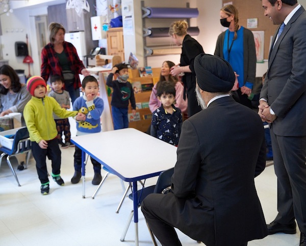 photo - Minister and MP Harjit Sajjan took some time out to meet some of the kids at the centre; MP Taleeb Noormohamed is standing to the minister’s right