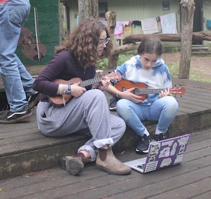 photo - two people playing guitars at Camp Miriam