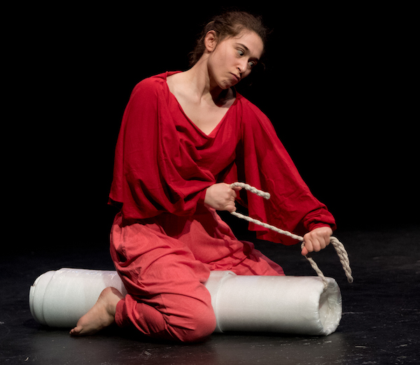 photo - In this scene from their solo physical comedy The Moaning Yoni, Joylyn Secunda is playing the vulva character, Yoni, who is based on the archetype of the Jewish mother (inspired by their own grandmother) – Yoni is strangling the Disembodied Voice of the Patriarchy with a tampon string