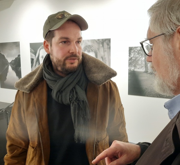 photo - Max Czollek, left, speaks with Prof. Chris Friedrichs, after Czollek launched his new book here Jan. 19