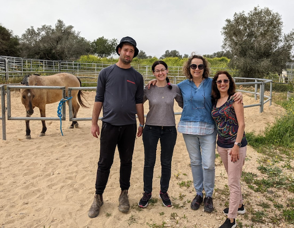 photo - At the therapeutic horse farm in Meir Shfeya Youth Village are, left to right, Yuval Perry, Moran Nir, Rachel David and Orly Sivan. Perry is a horse groomer at the farm, and David and Sivan are two of its four founders. Nir is manager of campaign and operations for JNF Pacific