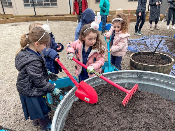 photo - Vancouver Talmud Torah students filling planters at the Vancouver Jewish Community Garden