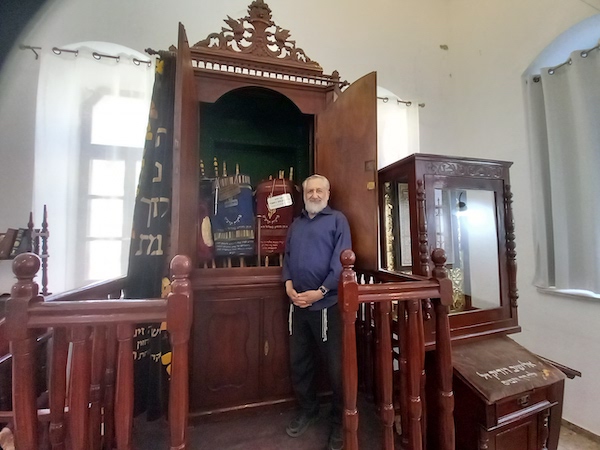 photo - Rabbi Itzhak Marmorstein – a former spiritual leader of Vancouver’s Congregation Or Shalom – stands beside the ark in Beit HaRav Kook, where he is the gabbai (sexton)