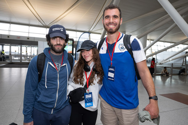 photo - Yitzchak Ickovich (right) before boarding the plane at JFK Airport in New York Aug. 22
