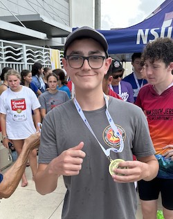 photo - Daniel Litvak with his gold medal, for winning the 100 freestyle swimming relay at the JCC Maccabi Games in Fort Lauderdale