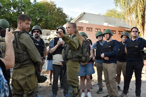 photo - On Oct. 31, among the ruins of Kibbutz Be’eri, Israel Defence Forces personnel brief a delegation of Conservative rabbis and lay leaders from the United States, Canada and Britain, which was on a three-day solidarity mission organized by the Fuchsberg Jerusalem Centre