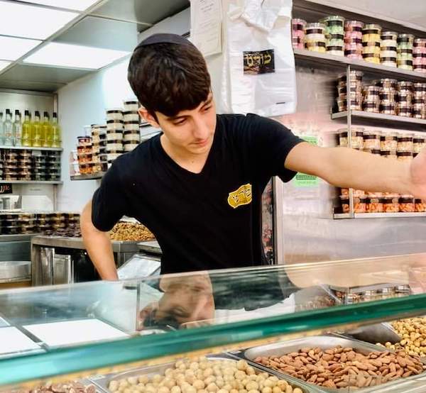 photo - Teenagers are filling in for drafted reservists at Jerusalem's Machane Yehuda market
