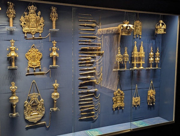 photo - The Jewish Museum of Switzerland’s display of Torah crowns and breastplates, and yads (pointers used to help read the text)