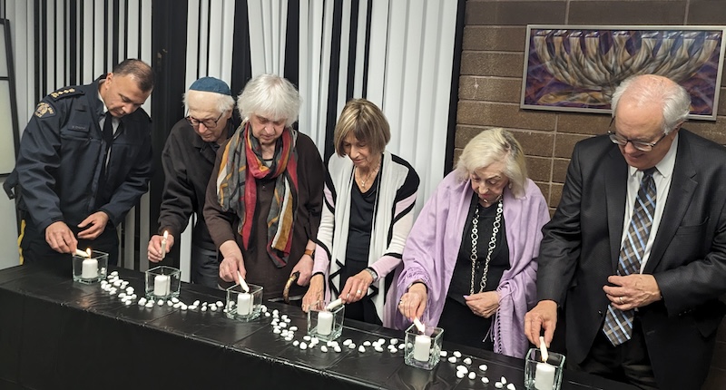 photo - Richmond RCMP Chief Superintendent Dave Chauhan, left, lights memorial candles with survivors David Schaffer, Sidi Schaffer, Amalia Boe-Fishman and Ilona Mermelstein, and Richmond Mayor Malcolm Brodie at a commemoration of International Holocaust Remembrance Day, at the Bayit, in Richmond, on Jan. 25