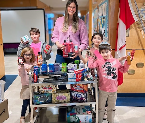 photo - Courtney Cohen with Richmond Jewish Day School students, who generously collected personal hygiene items for this year’s Rose’s Angels