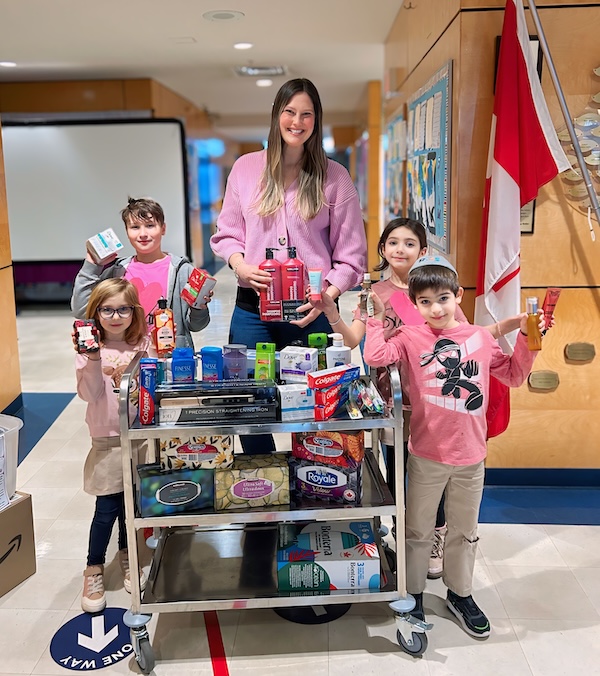 photo - Courtney Cohen with Richmond Jewish Day School students, who generously collected personal hygiene items for this year’s Rose’s Angels